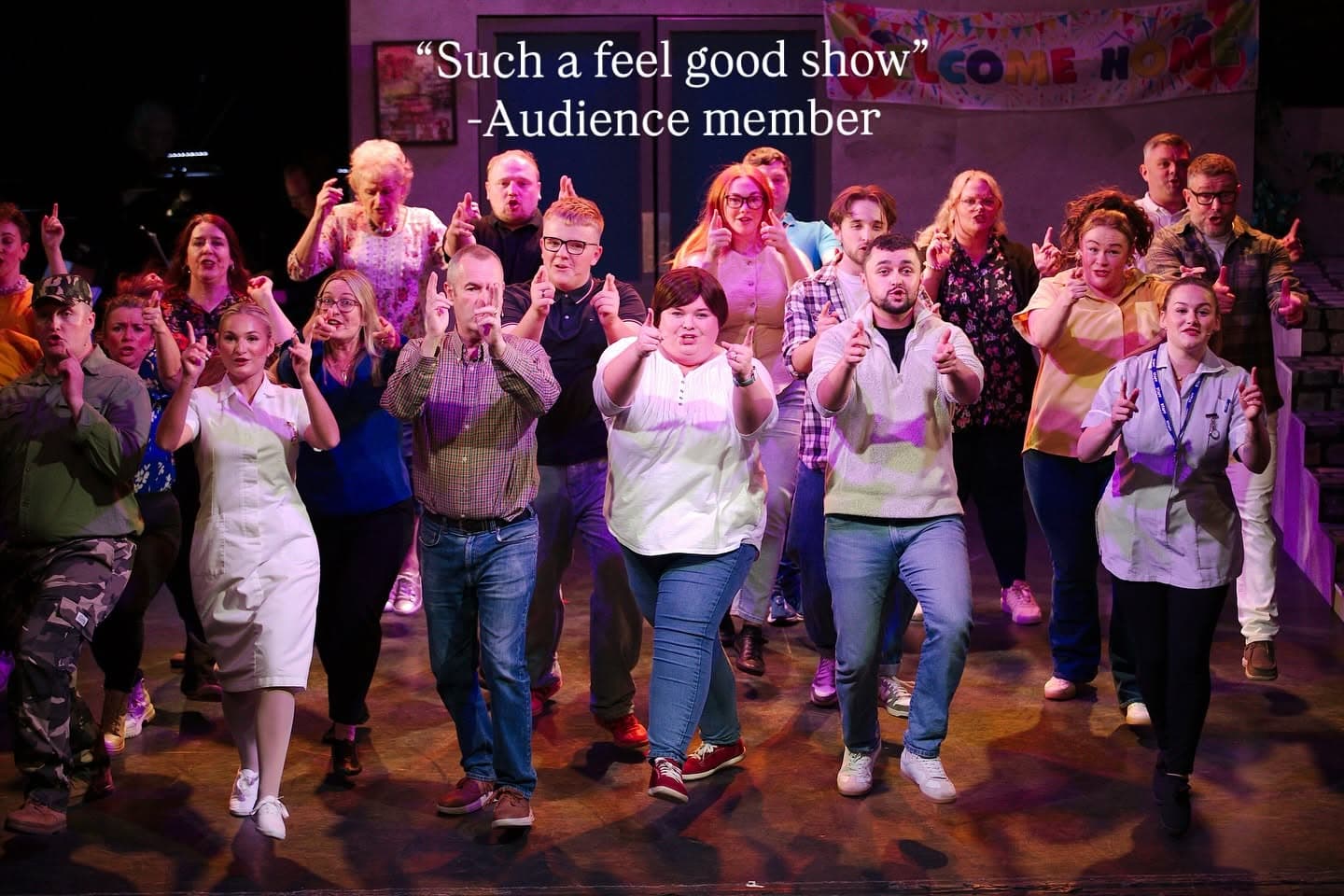 Full company on stage during Sunshine on Leith, with an audience member's review overlaid: Such a feel good show